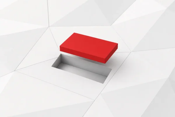 Una pieza rectangular roja levantada sobre el hueco de un panel facetado blanco, a punto de encajar